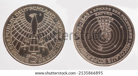 Germany - circa 1973 : a 5 Deutsche Mark coin of the Federal Republic of Germany with the cote of arm eagle and the orbit of the fixed stars as a commemoration of Nicolaus Copernicus

