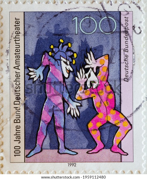 GERMANY - CIRCA 1992 : a postage stamp\
from Germany, showing two Harlequin actors in the theater. 100\
years of the Association of German Amateur Theaters\

