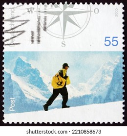 GERMANY - CIRCA 2005: A Stamp Printed In Germany Shows Postman On Snowy Hillside, Postal Worker, Circa 2005