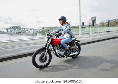 Germany- cologne- young woman riding motorcycle on bridge - Powered by Shutterstock