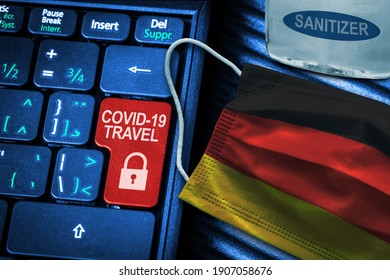 Germany COVID-19 Coronavirus Travel Restrictions Concept Showing Red Key Warning On Keyboard With German Flag Face Mask And Hand Sanitizer. New Normal In Global Travel.