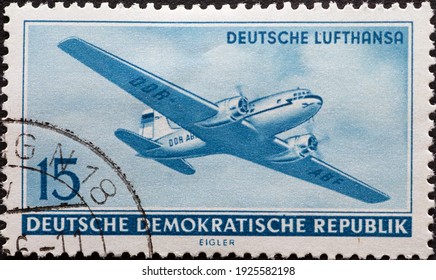 GERMANY, DDR - CIRCA 1956  : A Postage Stamp From Germany, GDR Showing A Russian Aircraft Ilyushin Il-14 (Il 14) Of Lufthansa In Flight From The Bottom Right. Opening Of Civil Aviation In The GDR 