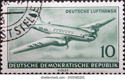 GERMANY, DDR - CIRCA 1956  : A Postage Stamp From Germany, GDR Showing A Russian Aircraft Ilyushin Il-14 (Il 14) Of Lufthansa In Flight From Top Left. Opening Of Civil Aviation In The GDR 