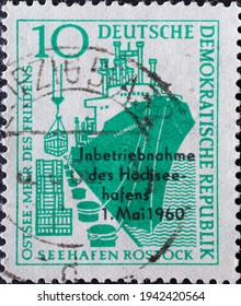 GERMANY, DDR - CIRCA 1960  : A Postage Stamp From Germany, GDR Showing An Ocean Cargo Ship Loading General Cargo On The Quay. With Imprint: Commissioning Of The Rostock High Sea Port 