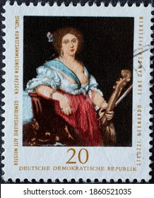 GERMANY, DDR - CIRCA 1976 : A Postage Stamp From Germany, GDR Showing A Portrait Of A Woman: A Viola Player; By Bernardo Strozzi. State Art Collections Dresden, Old Masters Gallery: Paintings