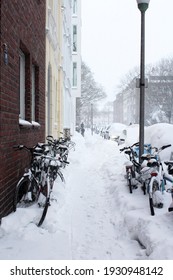 Münster, Germany - Feb 7 2021: Muenster Kreuzviertel Snowed In After A Snowstorm. Bicycles Parked Along Sidewalk.