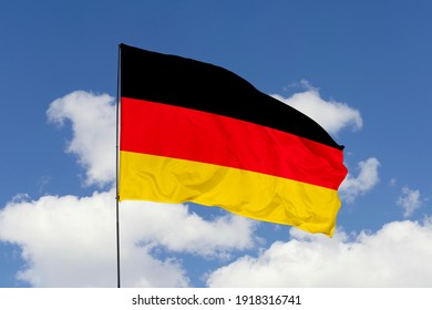 Germany flag isolated on the blue sky with clipping path. close up waving flag of Germany. flag symbols of Germany. - Shutterstock ID 1918316741