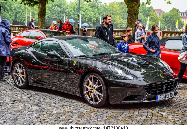 GERMANY, FULDA - JUL 2019: black FERRARI\
CALIFORNIA Type F149 coupe is a grand touring sports car produced\
by the Italian automotive manufacturer Ferrari. It is a two-door\
hard top convertible.