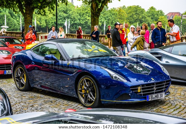 GERMANY, FULDA - JUL 2019: dark blue FERRARI\
CALIFORNIA Type F149 coupe is a grand touring sports car produced\
by the Italian automotive manufacturer Ferrari. It is a two-door\
hard top convertible.