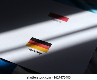 Germany / German With Poland / Polish Flag In A Paper With Sunlight / Sun Shine