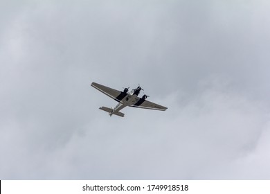 GERMANY, HAMBURG - JUNE 14, 2012: The Lufthansa's historical Junkers J52 with aircraft registration number D-AQUI seen from below while flying over Hamburg on a cloudy day.