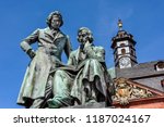 Germany, Hanau: National memorial statue of famous Grimm Brothers in the city center of the German town with town hall and blue sky in background - concept culture fairy tales art travel history
