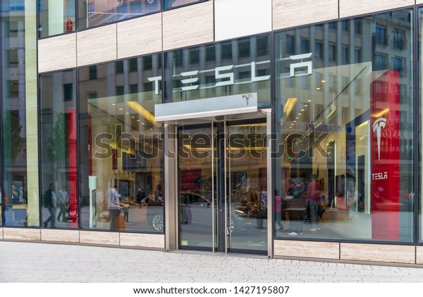 Düsseldrof, Germany\
- June 2019: Outdoor sunny view in front of exterior glass wall\
facade and entrance Tesla store at Kö-Bogen shopping mall near\
Schadowplatz in Düsseldorf, Germany.\
