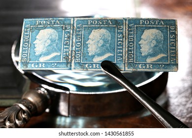 GERMANY - JUNE 9, 2019: Stripe Of 3 Kingdom Of Sicily 2 Grana Stamps From 1859 Held By Tweezers. 