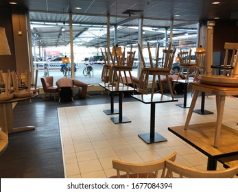 Tönisvorst, Germany - March 19. 2020: View Into Empty Closed Restaurant With Chairs Stapled On Tables During Corona Crisis