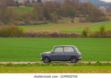 Münsingen, Germany - May 1, 2022: Mini Cooper British Oldtimer Vintage Car On A Country Road Near Münsingen, Germany.