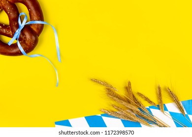 Germany october fest concept. Wheat, sweet tasty bread snack pretzel as snack to germany beer on yellow background.  Ads event of october beer festival in autumn october month