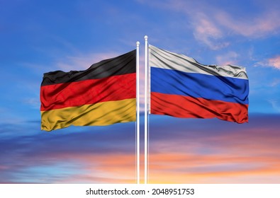 Germany and Russia two flags on flagpoles and blue cloudy sky  - Shutterstock ID 2048951753