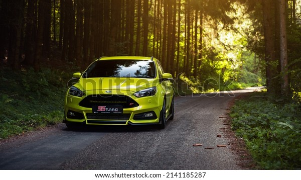 Baden-Württemberg, Germany -\
September 07 2016: lime green Ford Focus ST driving through the\
pine forest