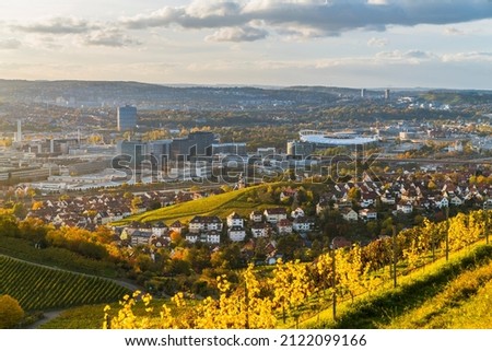 Germany, Stuttgart city  skyline panorama landscape view above industry, houses, streets, arena in basin at sunset