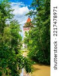 Germany, Waiblingen historical old town gate building with bridge over rems river in summer on sunny day between green nature landscape