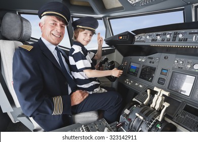 Germany,Bavaria,Munich,Senior pilot and boy in airplane cockpit