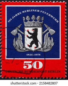 GERMANY-BERLIN - CIRCA 1975: a postage stamp from GERMANY-BERLIN, showing the historical coat of arms with a bear and fire axes of the Berlin fire brigade .125 years . Circa 1975