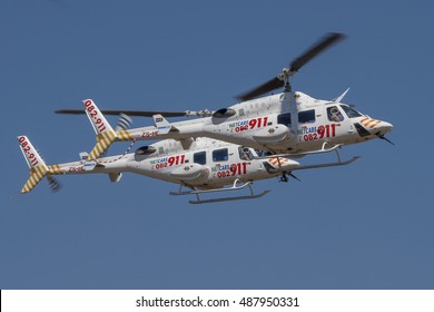 GERMISTON, SOUTH AFRICA-AUGUST 21 2016: A Pair Of Netcare 911 Helicopters Fly Past In Formation At The Rand Airshow At Rand Airport.