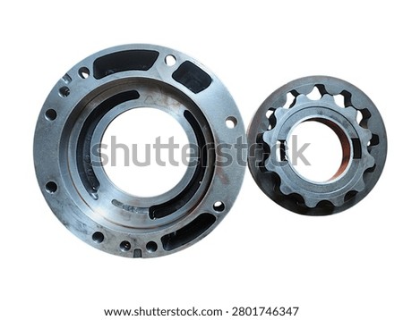 Gerotor internal gear set inside its circular flange housing for automotive or industrial oil pump isolated on black background.