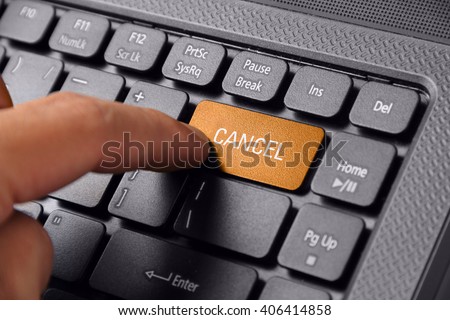 Gesture of a hand finger pushing the CANCEL button on laptop