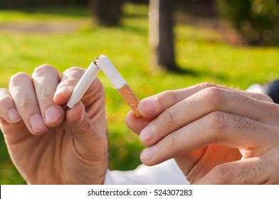 Gesture For Quit Smoking, Anti Smoking,  Male Hand Crushing Cigarette, Non Smoker. Man Has Decided To Stop Smoking.