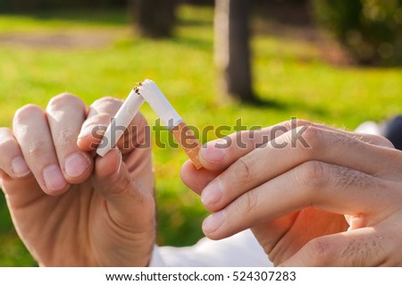 Gesture for quit smoking, Anti Smoking,  male hand crushing cigarette, Non Smoker. man has decided to stop smoking.