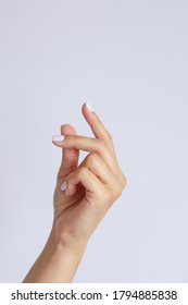 Gesture and sign, female hand on a white background. hand click or snapping fingers - Shutterstock ID 1794885838