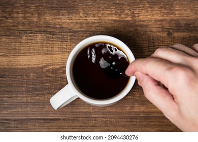 Gesture Of Stirring A Cup Of Black Coffee In Top View