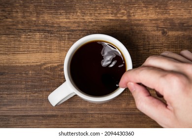 Gesture Of Stirring A Cup Of Black Coffee In Top View