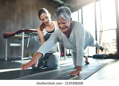 Get fit and have fun while doing it. Shot of a senior woman working out with her physiotherapist. - Powered by Shutterstock