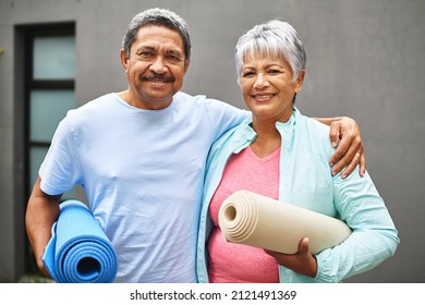 Get fit, stay fit. Portrait of a happy older couple carrying their exercise mats outdoors. - Powered by Shutterstock