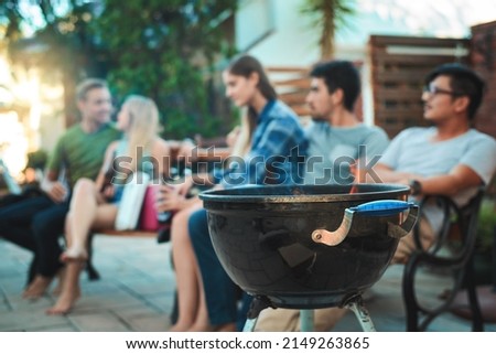 Similar – Woman holding lemonade glass and friends cooking in barbecue