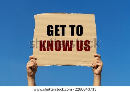 Get to know us text on box paper held by 2 hands with isolated blue sky background. This message board can be used as business concept to inform audience to know us more.