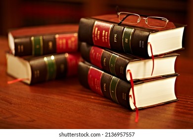 Get To Know Your Rights. Shot Of A Stack Of Legal Books And A Pair Of Glasses On A Table In A Study.