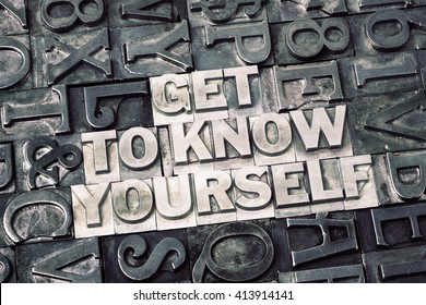 get to know yourself phrase made from metallic letterpress blocks with dark letters background