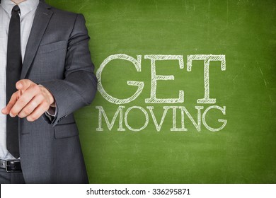 Get Moving On Blackboard With Businessman Finger Pointing