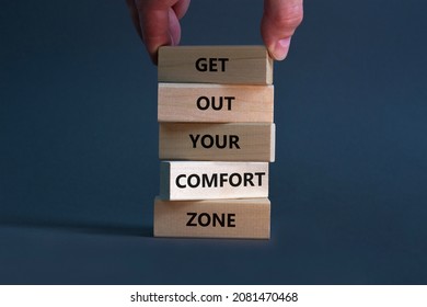 Get out your comfort zone symbol. Wooden blocks with words Get out your comfort zone on beautiful grey background, copy space. Businessman hand. Business, out from comfort zone concept.