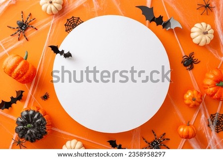 Get ready for a hair-raising Halloween night with orange isolated background adorned with creepy Halloween-themed decorations with empty round frame, perfect for advertising or text placement