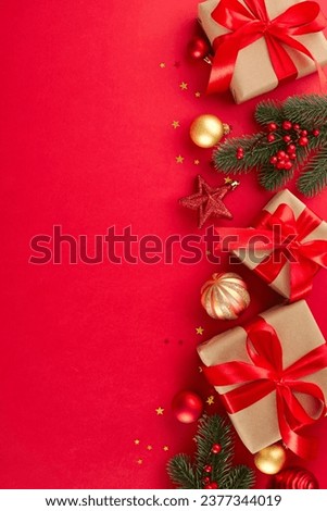 Get ready to light up the holiday season with perfect gifts. Top view vertical photo of festive present boxes, holiday baubles, fir twigs, shiny stars on red background with advert zone