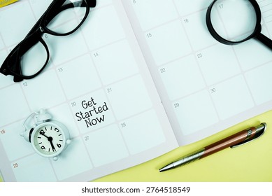 Get Started Now message written on calendar date with alarm clock, glasses and magnifying glass on yellow background
