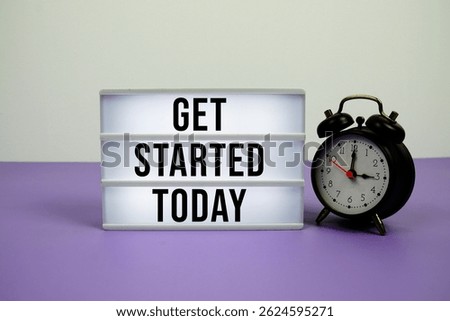 Get Started Today text on LED lightbox with alarm clock on purple background