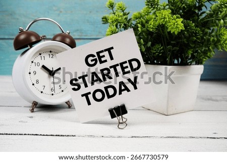Get Started Today text written on paper card with alarm clock on wooden background