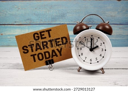 Get Started Today text written on paper card with alarm clock on wooden background