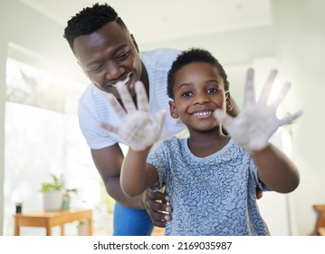 To get them clean, we first get them soapy. Portrait of a boy holding up his soapy hands while standing in a bathroom with his father at home. - Powered by Shutterstock